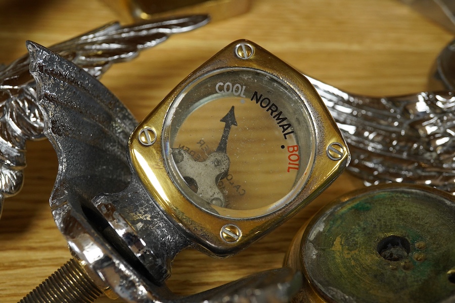 Four car mascot Calormeters by Wilmot-Breeden, three examples with winged bases, together with three additional winged bases, two radiator caps, a brass bonnet mounting, and other related fittings. Condition - fair to go